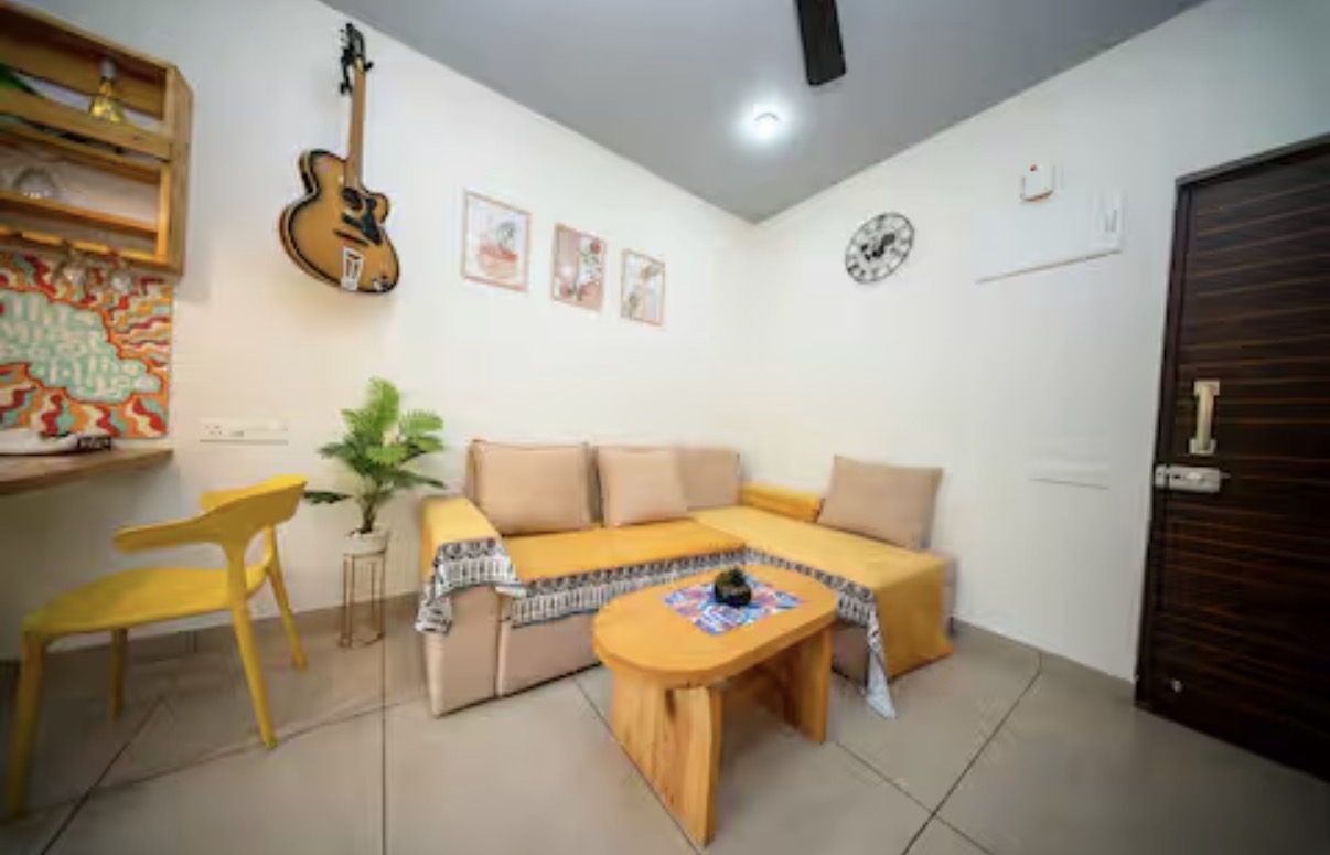 Cozy lounge corner with guitar and warm textiles