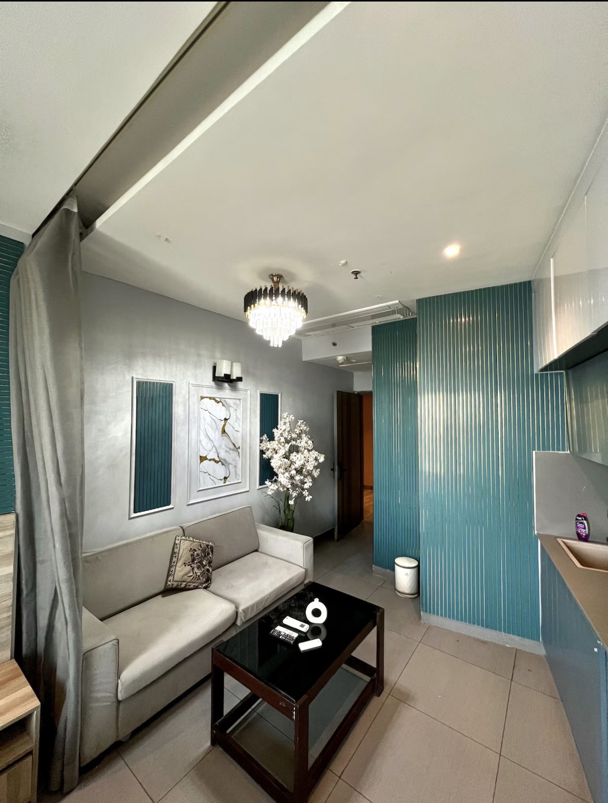 Compact designer living space with teal fluted panelling