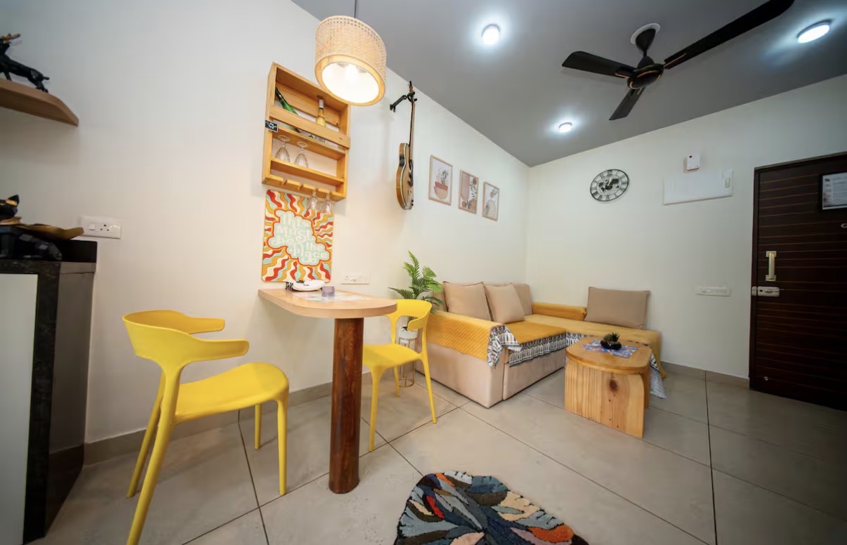 Dining nook with yellow chairs and gallery wall