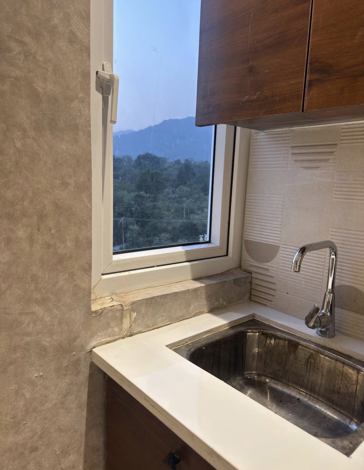 Kitchen window framing the Doon valley hills